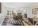 The dining room features a dining table, hardwood floors and is naturally lit at 4312 S Woodbridge Ln, New Palestine, IN 46163