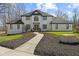 Beautiful exterior of a white brick home with a winding walkway and manicured lawn at 4312 S Woodbridge Ln, New Palestine, IN 46163