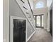 Foyer featuring an arched window, staircase, and stylish dark tile flooring at 4312 S Woodbridge Ln, New Palestine, IN 46163