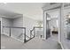 Hallway featuring contemporary decor, natural light, and a black railing at 4312 S Woodbridge Ln, New Palestine, IN 46163