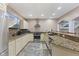Well-appointed bar area features stainless appliances and stone backsplash at 4312 S Woodbridge Ln, New Palestine, IN 46163