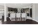 Kitchen with an island, granite countertops, black cabinets, and hardwood floors at 4312 S Woodbridge Ln, New Palestine, IN 46163