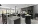 Modern kitchen with granite countertops, black cabinets, and stainless steel appliances at 4312 S Woodbridge Ln, New Palestine, IN 46163