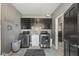 Laundry room boasting modern washer and dryer, stylish cabinets, and granite countertops at 4312 S Woodbridge Ln, New Palestine, IN 46163