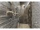 Enjoy this luxurious shower with stone walls, multiple shower heads, and a built-in bench at 4312 S Woodbridge Ln, New Palestine, IN 46163