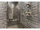 Enjoy this luxurious shower with stone walls, multiple shower heads, and a built-in bench at 4312 S Woodbridge Ln, New Palestine, IN 46163