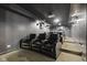 Basement theater room with tiered seating and a projector at 4312 S Woodbridge Ln, New Palestine, IN 46163