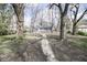 View of a long backyard with mature trees and a small storage shed at 4342 Lasalle St, Indianapolis, IN 46205