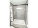 Full bath includes a shower head, towel rack and window with sleek grey tile at 4342 Lasalle St, Indianapolis, IN 46205