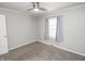The bedroom has carpeted flooring, a ceiling fan and a large window with blinds at 4342 Lasalle St, Indianapolis, IN 46205