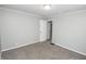 Carpeted bedroom with a white door and neutral paint; spacious for comfort at 4342 Lasalle St, Indianapolis, IN 46205