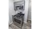 Picture of the kitchen with gray cabinets, stainless steel stove, and laminate floors at 4342 Lasalle St, Indianapolis, IN 46205