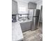 View of the kitchen featuring stainless steel appliances, updated cabinets, and stone countertops at 4342 Lasalle St, Indianapolis, IN 46205