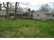 Grassy backyard with fenced perimeter, storage shed, and mature trees at 4431 Bertrand Rd, Indianapolis, IN 46222