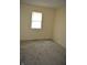 Bedroom featuring neutral walls, gray carpeting, and a bright window at 4431 Bertrand Rd, Indianapolis, IN 46222