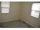 Bright bedroom featuring neutral walls, gray carpeting, and two windows at 4431 Bertrand Rd, Indianapolis, IN 46222