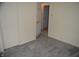 Bedroom view featuring neutral walls, gray carpeting, closet, and an open doorway at 4431 Bertrand Rd, Indianapolis, IN 46222