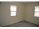 Bedroom featuring neutral walls, gray carpeting, and two bright windows at 4431 Bertrand Rd, Indianapolis, IN 46222