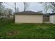 Exterior shot of the detached garage with tan siding and a dark shingled roof at 4431 Bertrand Rd, Indianapolis, IN 46222