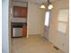 Kitchen area with wood cabinets, stainless steel dishwasher, and an adjacent dining area with a hanging light fixture at 4431 Bertrand Rd, Indianapolis, IN 46222