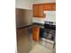 Kitchen showcasing stainless steel refrigerator and range oven against wood cabinets at 4431 Bertrand Rd, Indianapolis, IN 46222