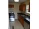 Kitchen features stainless steel appliances, wood cabinets, and a double stainless steel sink at 4431 Bertrand Rd, Indianapolis, IN 46222