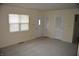 Open living room with carpet, windows, doors, and neutral paint, creating a welcoming space at 4431 Bertrand Rd, Indianapolis, IN 46222