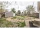 Fenced backyard with detached garage, some grass and concrete at 4742 Primrose Ave, Indianapolis, IN 46205