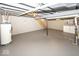 Exposed basement with painted concrete floor, washer/dryer, and staircase at 4742 Primrose Ave, Indianapolis, IN 46205