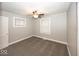 Cozy bedroom featuring a ceiling fan, two windows, and neutral gray carpet at 4742 Primrose Ave, Indianapolis, IN 46205