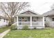 Charming home featuring a quaint front porch and well-manicured lawn at 4742 Primrose Ave, Indianapolis, IN 46205