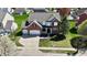 Expansive aerial view of a two-story home with an attached garage, lush green lawn, and mature trees at 5145 Greenheart Pl, Indianapolis, IN 46237