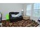 Relaxing bedroom nook with recliner chair, ottoman, and large bright window at 5145 Greenheart Pl, Indianapolis, IN 46237