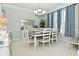 Elegant dining room featuring a large table, stylish chandelier, and neutral color scheme at 5145 Greenheart Pl, Indianapolis, IN 46237
