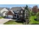 Lovely two-story home with brick accents, a well-maintained lawn, and mature landscaping at 5145 Greenheart Pl, Indianapolis, IN 46237