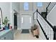 Bright and inviting foyer with high ceilings, staircase, and tiled floor at 5145 Greenheart Pl, Indianapolis, IN 46237