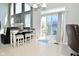 Bright living area with large windows, a fireplace, and access to the outdoor deck at 5145 Greenheart Pl, Indianapolis, IN 46237