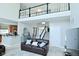 Open-concept living room with high ceilings, a staircase, and views into the kitchen at 5145 Greenheart Pl, Indianapolis, IN 46237