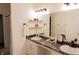Well-lit bathroom with double sinks, black marble countertop, and modern vanity lighting at 5301 Tanglewood Ln, Whitestown, IN 46075