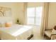 Sun-drenched bedroom featuring a bed, a cozy chair, and a window with sheer curtains at 5301 Tanglewood Ln, Whitestown, IN 46075