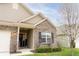 Close up of charming brick home with a well-manicured lawn and blooming tree at 5301 Tanglewood Ln, Whitestown, IN 46075