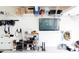 Well-organized garage with shelving, a TV, and an EV charger for electric vehicles at 5301 Tanglewood Ln, Whitestown, IN 46075