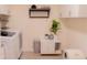 Bright laundry room with white cabinets, modern appliances, and a decorative plant at 5301 Tanglewood Ln, Whitestown, IN 46075