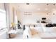 Bright and airy living room featuring a modern dining set, white sofa, and contemporary lighting at 5301 Tanglewood Ln, Whitestown, IN 46075