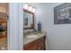 Stylish bathroom with a granite countertop vanity, sink, and decorative mirror at 6018 Maple Forge Cir, Indianapolis, IN 46254