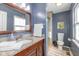 Beautiful bathroom with granite countertop, elegant vanity, and shower with glass doors at 6018 Maple Forge Cir, Indianapolis, IN 46254