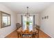 Elegant dining room featuring wood floors, a long wooden table, and a modern light fixture at 6018 Maple Forge Cir, Indianapolis, IN 46254
