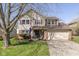 Charming two-story home featuring vinyl siding, a well-manicured lawn, and an attached two-car garage at 6018 Maple Forge Cir, Indianapolis, IN 46254