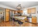 Open kitchen with an island, stainless steel appliances, and wood floors at 6018 Maple Forge Cir, Indianapolis, IN 46254