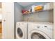 Convenient laundry room featuring washer, dryer, and wire shelving for efficient storage at 6018 Maple Forge Cir, Indianapolis, IN 46254
